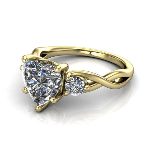 Lydia heart three stone engagement ring in 18K Yellow Gold, three-quarter perspective showing the brilliant heart-shaped center diamond flanked by two round side diamonds on a woven infinity shank
