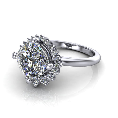 Matilda cushion halo engagement ring in 18K White Gold, three-quarter perspective showing the brilliant cushion-cut center diamond inside a sunburst halo of pointed rays with round accent diamonds clustered between them