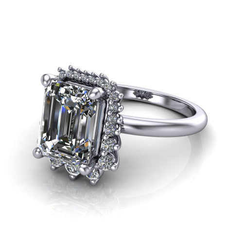 Matilda emerald halo engagement ring in 14K White Gold, three-quarter perspective showing the step-cut emerald center diamond inside a sunburst halo of pointed rays with round accent diamonds clustered between them