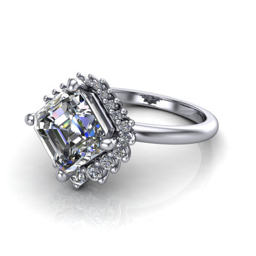Matilda square emerald halo engagement ring in 18K White Gold, three-quarter perspective showing the step-cut square emerald center diamond inside a sunburst halo of pointed rays with round accent diamonds clustered between them