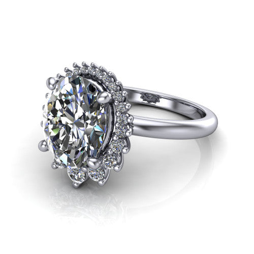 Matilda oval halo engagement ring in 14K White Gold, three-quarter perspective showing the brilliant oval center diamond inside a sunburst halo of pointed rays with round accent diamonds clustered between them