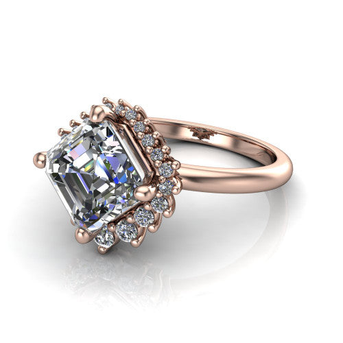 Matilda square emerald halo engagement ring in 14K Rose Gold, three-quarter perspective showing the step-cut square emerald center diamond inside a sunburst halo of pointed rays with round accent diamonds clustered between them