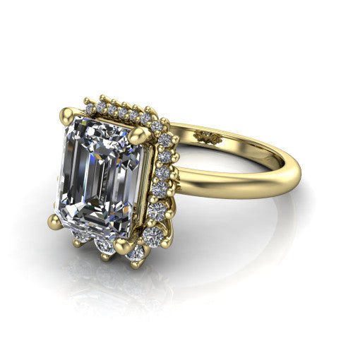 Matilda emerald halo engagement ring in 14K Yellow Gold, three-quarter perspective showing the step-cut emerald center diamond inside a sunburst halo of pointed rays with round accent diamonds clustered between them