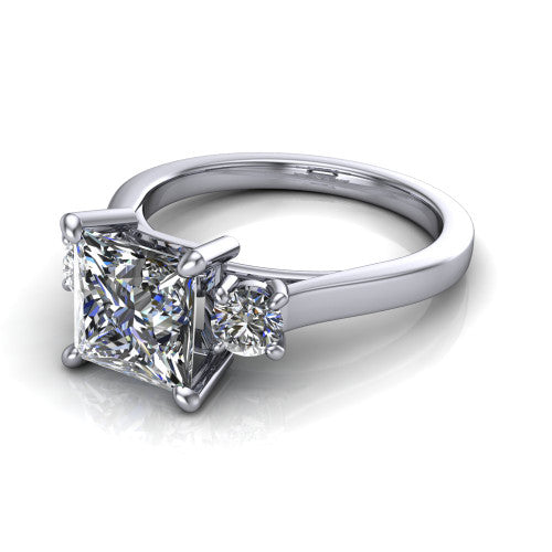 Olivia princess three stone engagement ring in Platinum, three-quarter perspective showing the brilliant princess-cut center diamond flanked by two round side diamonds on a squared flat-top shank