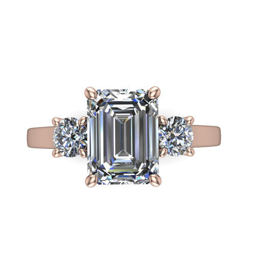 Olivia emerald three stone engagement ring in 14K Rose Gold, top-down view showing the step-cut emerald center diamond with two matched round side diamonds