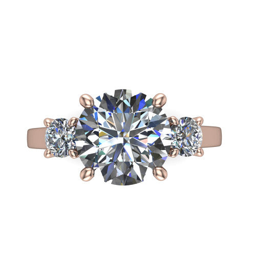 Olivia round three stone engagement ring in 18K Rose Gold, top-down view showing the brilliant round center diamond with two matched round side diamonds