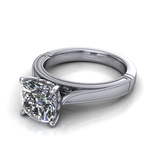 Adeline cushion solitaire engagement ring in Platinum, three-quarter perspective showing the brilliant cushion-cut center diamond on a wide flat-top milgrain band