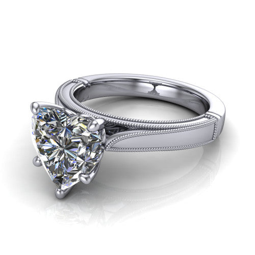 Adeline heart solitaire engagement ring in Platinum, three-quarter perspective showing the brilliant heart-shaped center diamond on a wide flat-top milgrain band