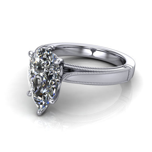Adeline pear solitaire engagement ring in 18K White Gold, three-quarter perspective showing the brilliant pear-cut center diamond on a wide flat-top milgrain band