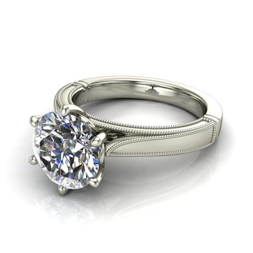 Adeline round solitaire engagement ring in Platinum, three-quarter perspective showing the brilliant round center diamond on a wide flat-top milgrain band