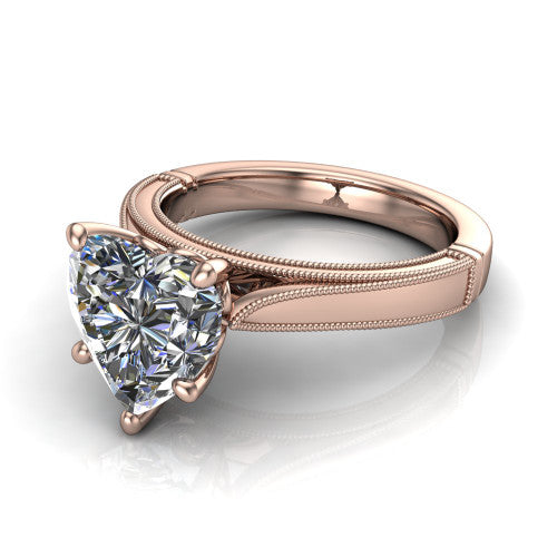 Adeline heart solitaire engagement ring in 14K Rose Gold, three-quarter perspective showing the brilliant heart-shaped center diamond on a wide flat-top milgrain band