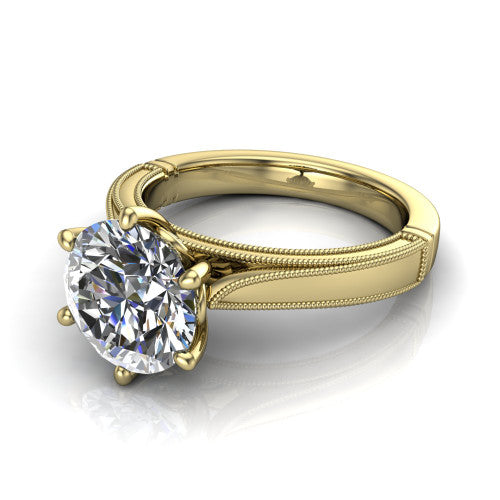 Adeline round solitaire engagement ring in 18K Yellow Gold, three-quarter perspective showing the brilliant round center diamond on a wide flat-top milgrain band