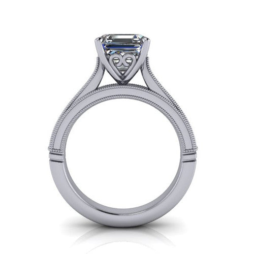 Adeline square emerald solitaire engagement ring in Platinum, through-finger front profile showing the heart filigree under-gallery and milgrain band edges