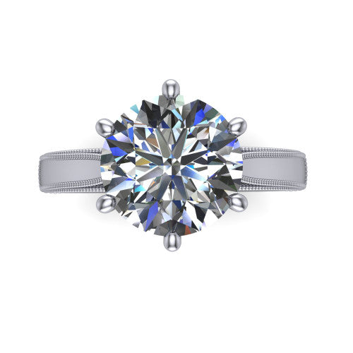 Adeline round solitaire engagement ring in 18K White Gold, top-down view showing the brilliant round center diamond held by four prongs above a squared milgrain band