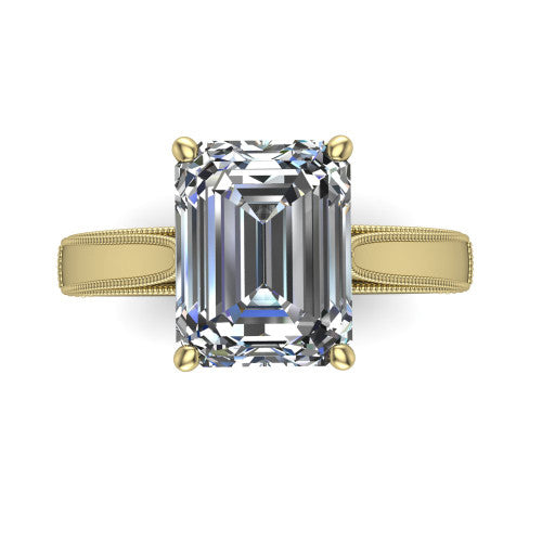 Adeline emerald solitaire engagement ring in 14K Yellow Gold, top-down view showing the step-cut emerald center diamond held by four prongs above a squared milgrain band