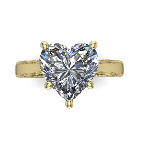 Adeline heart solitaire engagement ring in 18K Yellow Gold, top-down view showing the brilliant heart-shaped center diamond held by four prongs above a squared milgrain band