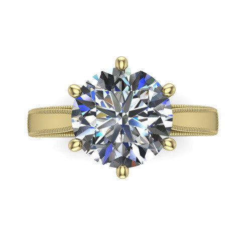 Adeline round solitaire engagement ring in 18K Yellow Gold, top-down view showing the brilliant round center diamond held by four prongs above a squared milgrain band