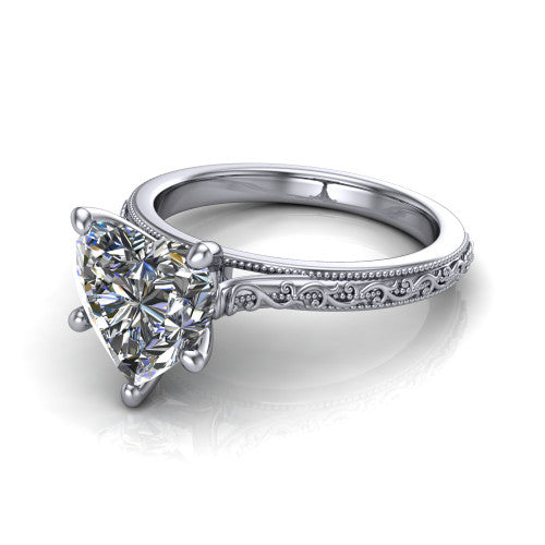 Violet heart solitaire engagement ring in Platinum, three-quarter perspective showing the brilliant heart-shaped center diamond on a hand-engraved scroll shank with milgrain edges
