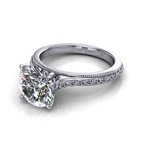 Violet round solitaire engagement ring in 18K White Gold, three-quarter perspective showing the brilliant round center diamond on a hand-engraved scroll shank with milgrain edges