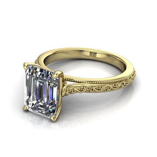 Violet emerald solitaire engagement ring in 18K Yellow Gold, three-quarter perspective showing the step-cut emerald center diamond on a hand-engraved scroll shank with milgrain edges