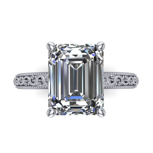 Violet emerald solitaire engagement ring in 18K White Gold, top-down view showing the step-cut emerald center diamond held by four prongs above the engraved shank