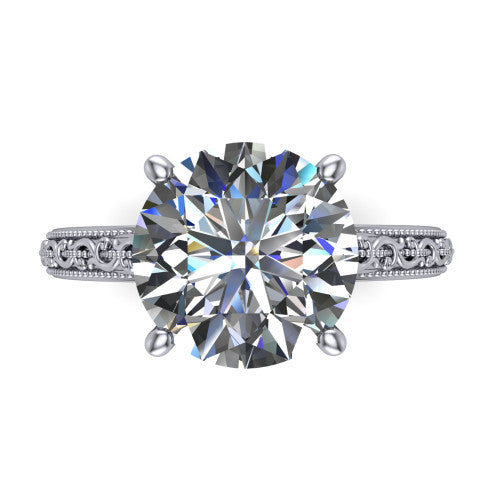 Violet round solitaire engagement ring in 14K White Gold, top-down view showing the brilliant round center diamond held by four prongs above the engraved shank