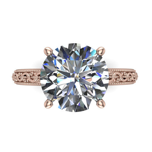 Violet round solitaire engagement ring in 18K Rose Gold, top-down view showing the brilliant round center diamond held by four prongs above the engraved shank