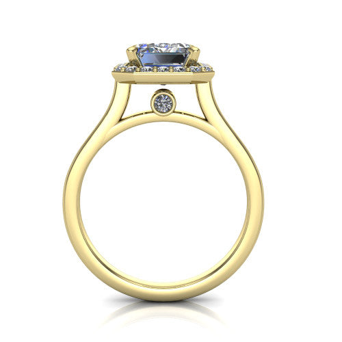 Anastasia emerald halo engagement ring in 14K Yellow Gold, through-finger front profile showing the halo head, cathedral shoulders, and hidden surprise diamond in the under-gallery