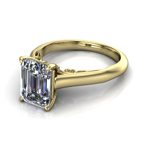 Saylor emerald solitaire engagement ring in 14K Yellow Gold, three-quarter perspective showing the step-cut emerald center diamond on a 4-prong cathedral head with filigree gallery