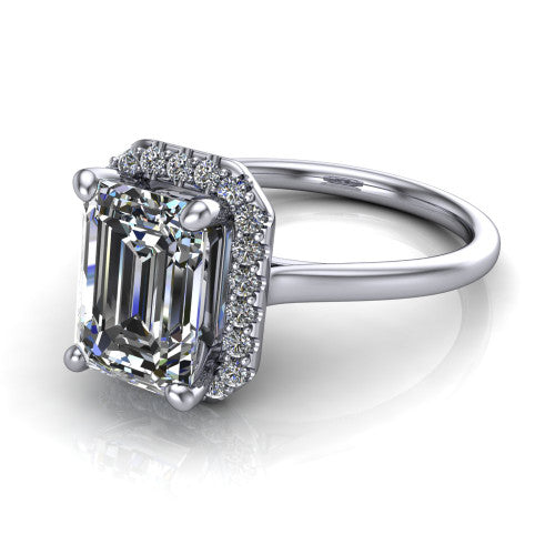 Florence emerald halo engagement ring in Platinum, three-quarter perspective showing the step-cut emerald center diamond inside a slim pave halo on a thin knife-edge band