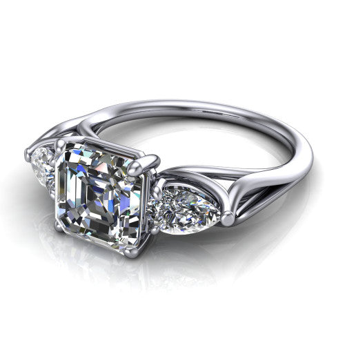 Journee square emerald three stone engagement ring in Platinum, three-quarter perspective showing the step-cut square emerald center diamond flanked by two pear side diamonds set sideways on tapered cathedral shoulders