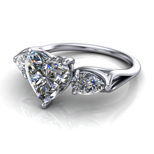 Journee heart three stone engagement ring in 18K White Gold, three-quarter perspective showing the brilliant heart-shaped center diamond flanked by two pear side diamonds set sideways on tapered cathedral shoulders