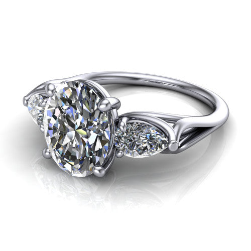 Journee oval three stone engagement ring in 18K White Gold, three-quarter perspective showing the brilliant oval center diamond flanked by two pear side diamonds set sideways on tapered cathedral shoulders