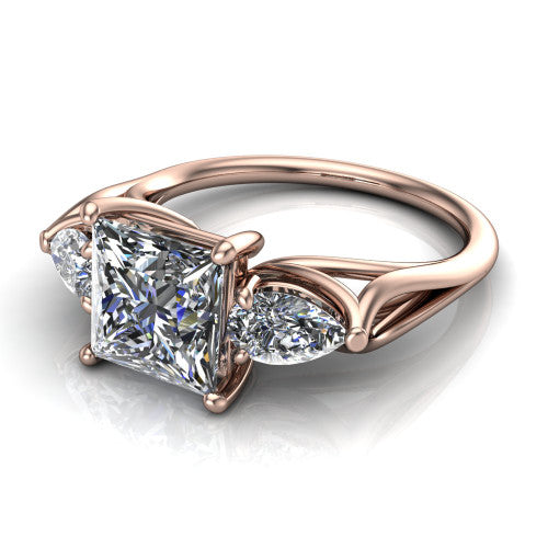 Journee princess three stone engagement ring in 14K Rose Gold, three-quarter perspective showing the brilliant princess-cut center diamond flanked by two pear side diamonds set sideways on tapered cathedral shoulders