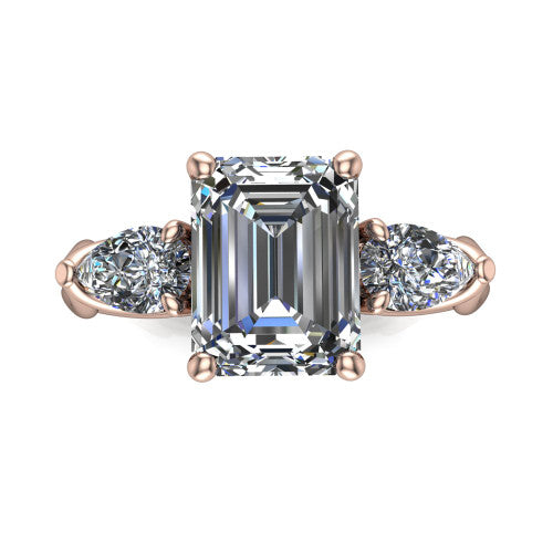 Journee emerald three stone engagement ring in 18K Rose Gold, top-down view showing the step-cut emerald center diamond with two pear side diamonds pointing outward