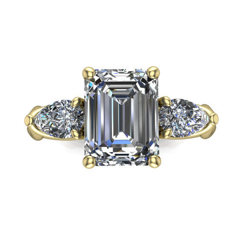 Journee emerald three stone engagement ring in 18K Yellow Gold, top-down view showing the step-cut emerald center diamond with two pear side diamonds pointing outward