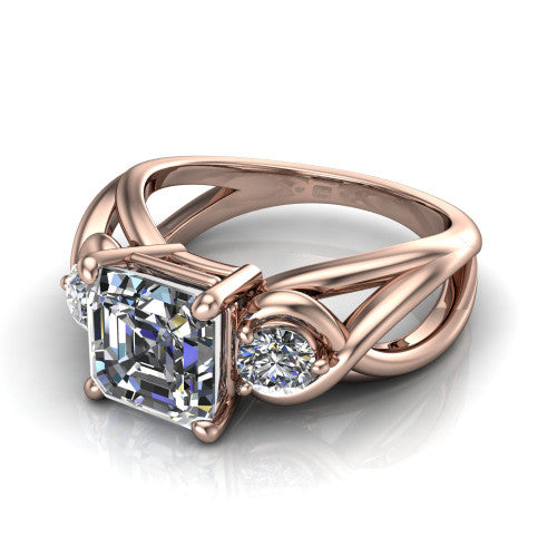 Ottilie square emerald three stone engagement ring in 18K Rose Gold, three-quarter perspective showing the step-cut square emerald center diamond flanked by two round side diamonds on a braided ribbon shank