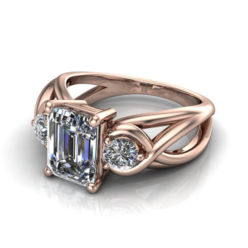 Ottilie emerald three stone engagement ring in 14K Rose Gold, three-quarter perspective showing the step-cut emerald center diamond flanked by two round side diamonds on a braided ribbon shank