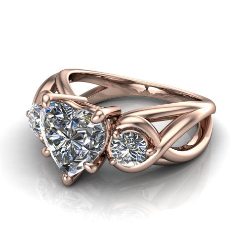 Ottilie heart three stone engagement ring in 18K Rose Gold, three-quarter perspective showing the brilliant heart-shaped center diamond flanked by two round side diamonds on a braided ribbon shank