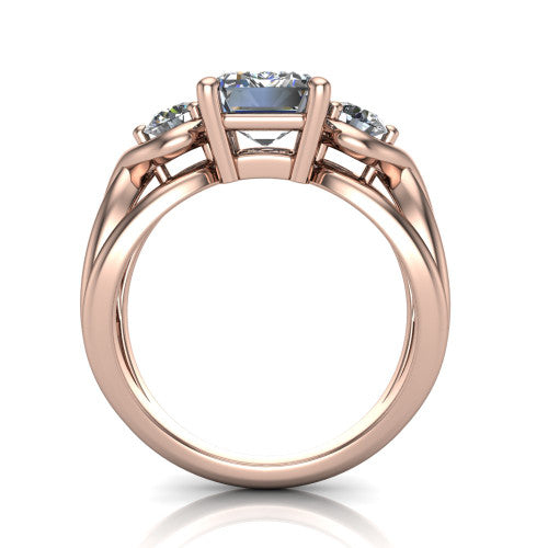 Ottilie emerald three stone engagement ring in 18K Rose Gold, through-finger front profile showing the three-stone head and sculpted scroll basket