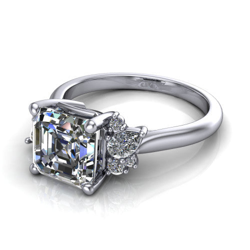 Evie emerald vintage engagement ring in Platinum, three-quarter perspective showing the cathedral rise and accent clusters fanning out on both sides of the center