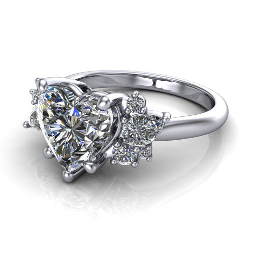 Evie heart three stone engagement ring in Platinum, three-quarter perspective showing the cathedral rise and accent clusters fanning out on both sides of the center