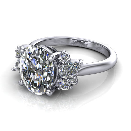 Evie oval three stone engagement ring in 18K White Gold, three-quarter perspective showing the cathedral rise and accent clusters fanning out on both sides of the center
