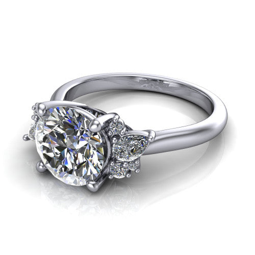 Genevieve round three stone engagement ring in Platinum, three-quarter perspective showing the brilliant round center diamond flanked by clusters of small round accent diamonds on tapered cathedral shoulders