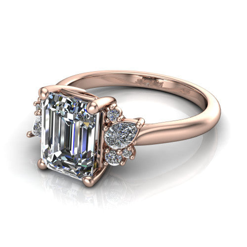 Genevieve emerald three stone engagement ring in 18K Rose Gold, top-down view showing the step-cut emerald center diamond with diamond clusters on each side