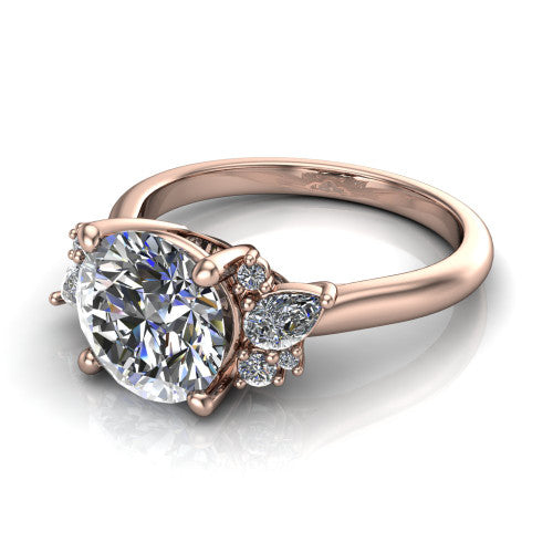 Evie round three stone engagement ring in 18K Rose Gold, three-quarter perspective showing the cathedral rise and accent clusters fanning out on both sides of the center