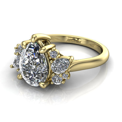 Genevieve pear three stone engagement ring in 14K Yellow Gold, three-quarter perspective showing the brilliant pear-cut center diamond flanked by clusters of small round accent diamonds on tapered cathedral shoulders