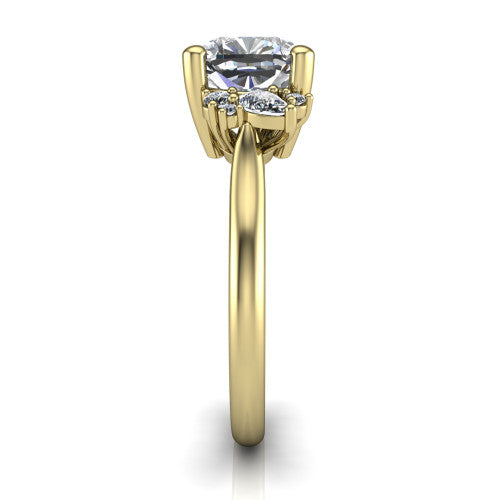 Genevieve cushion three stone engagement ring in 18K Yellow Gold, side profile showing the cluster head, tapered cathedral shoulders, and polished band