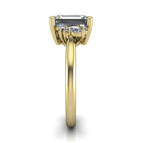 Genevieve emerald three stone engagement ring in 18K Yellow Gold, side profile showing the cluster head, tapered cathedral shoulders, and polished band