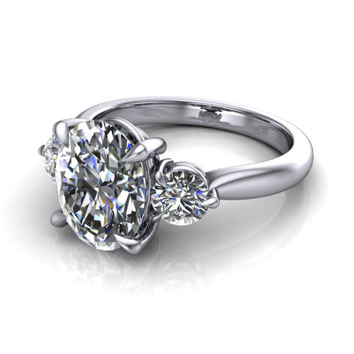 Juniper oval three stone engagement ring in Platinum, three-quarter perspective showing the brilliant oval center diamond flanked by two round side diamonds on a rounded plain band